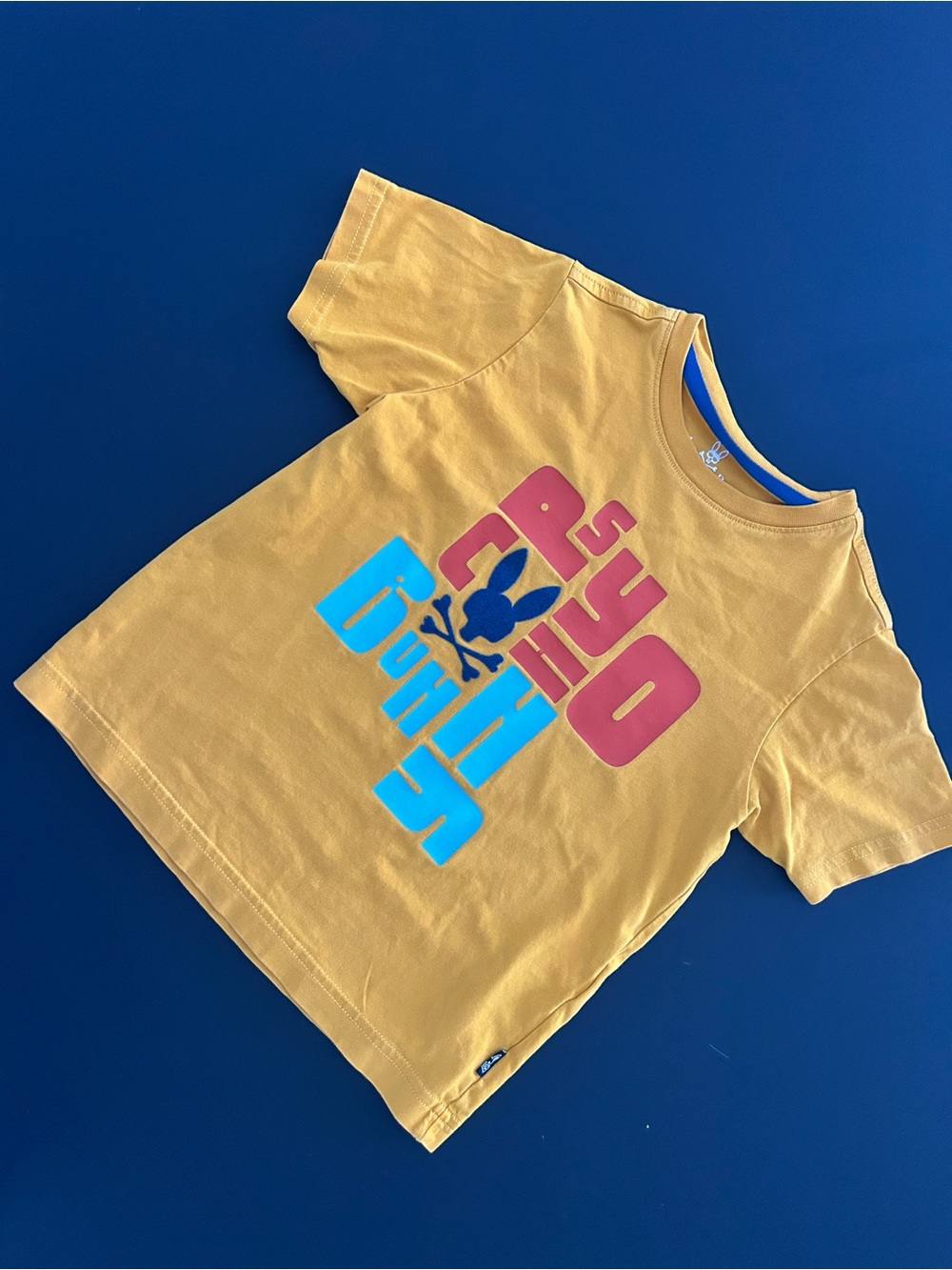 Psycho Bunny Mustard Yellow Graphic Kids Tee with Pink and Blue Logo